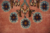 Close-up of the full, hand-knotted pile showing Rococo floral motifs in sky blue, navy, and red.