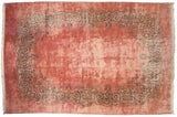 Full layout of a vintage Kerman rug with a dusty rose open field and intricate scrolling Rococo border.