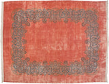 A vintage fine Kerman carpet with an open dusty rose field and a wide, floating scrolling vine border in blue.