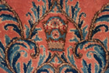 A blossomed stem motif with Rococo scrolling vines in dusty rose, sky blue, and navy.