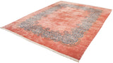 Angled perspective of a fine Persian Kerman rug's plush dusty rose pile and detailed blue Rococo border.