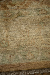 High-luster plush wool pile showing the corner and fringe detail of a vintage Oushak carpet.