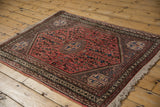 Dusty blush field featuring playful plants, birds, and stepped medallion corner of a vintage Abadeh rug.