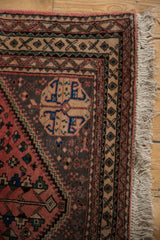Vintage Persian Abadeh rug corner with stepped blue medallion, geometric borders, and fringe.