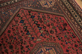 Dusty blush field of the vintage Abadeh rug with geometric plants, birds, and serpent motifs.