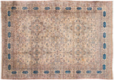 Antique Kermanshah carpet with starburst medallions and a navy border with Persian poetry cartouches.