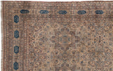 Poetic navy blue cartouches within the complex floral border of an antique Kermanshah rug.