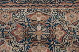 Signature border cartouche featuring intricate floral work in navy, gold, and terra cotta.