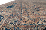 Low-angle view showing the signature cartouches along the border of an antique Persian carpet.