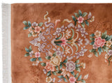 Vintage Art Deco carpet corner, plush copper pile, white fringe, and carved pastel flowers.