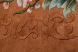 Textured pile detail of vintage Art Deco carpet with dimensional bronze carving and pastel blossoms.
