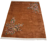 Corner detail of Art Deco carpet with dimensional carved border and blush, mauve floral.