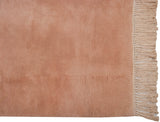 Plush pale dusty rose pile and ivory fringe detail of a vintage Japanese Art Deco rug.