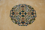 Densely ornamented scrolling vines in indigo, mauve, green on a Japanese Arts and Crafts rug's ivory field.