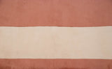 Detail of the vintage Art Deco carpet's even pile, showing apricot and ivory color bands.