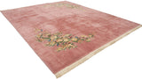 Pink field of vintage Japanese Art Deco rug, showing dimensional floral carving and ivory fringe.