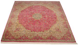 Angled view of a square Kerman carpet showing its pink millefleur field and starburst medallion.