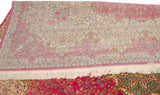Reverse side of the vintage Bulgarian carpet showing cosmetic staining and the hand-knotted weave.