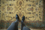 Mohajeran Sarouk rug's ivory field with sprawling branches, diminutive buds, and slate blue border.