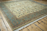 Vintage Indian Sarouk rug with ivory field, slate blue-gray border, and sprawling floral motifs.