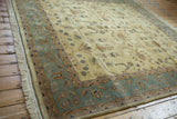 Vintage Indian Mohajeran Sarouk rug detail: slate blue border, ivory field, blush blossoms.