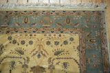 Vintage Indian Sarouk design rug corner featuring slate blue-gray border and ivory field with sprawling blossoms.