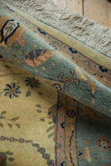 Vintage Indian Mohajeran Sarouk rug, rolled segment showing slate blue, ivory, and ornate pile.