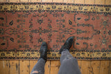 Mohajeran Sarouk runner with dark rose field, navy blue floral motifs, and antique ivory border.