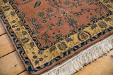 Indian Mohajeran Sarouk runner corner: dark rose field blossoms, ornate ivory border, fringe.