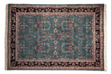 Vintage Indian Mohajeran Sarouk carpet with a sprawling floral design on a dusty teal field with a black border.