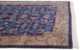 Corner detail of the Arts and Crafts carpet showing a beige vine border and clean, full ivory fringe.