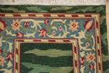Corner view of the vintage Indian rug showing the scrolling vinery and palmette border with its full pile.