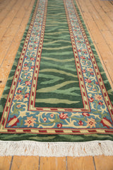 Long view of an Arts and Crafts runner rug with its green striated field and floral palmette border.