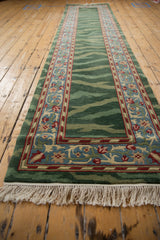 Low-angle view down the vintage Indian runner, highlighting its striated green field and fringe.