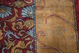 Arts and Crafts Indian carpet detail with scrolling florals, gold vines, wine red, and pale denim border.