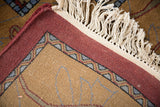 Hand knotted Indian Arts and Crafts carpet showcasing its woven backing and secured wine red edge.