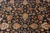Detailed floral cross-sections and scrolling vinery in copper and gold on a plush navy blue pile.