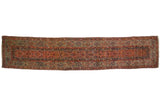 An early Fereghan runner with a red lattice-paneled field and a wide, signature green border.