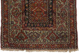 The wide, classic green main border of a collectible 19th-century Persian Fereghan rug.