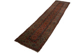 Full length of an antique Fereghan runner showing its lattice pattern and signature green border.