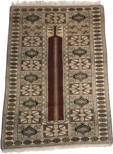 Top corner of vintage Melas rug, with coffee brown, dusty green geometric borders and beige fringe.