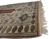 Original beige fringe and intact side cord selvage of a vintage Melas rug.