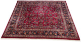 The brilliant gem tones of a vintage Sarouk carpet with allover floral sprays across a ruby red field.