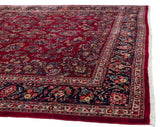 Intact side cord selvage and full pile on the corner of a fine vintage Sarouk carpet.