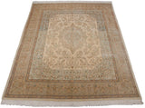 A vintage Tabriz carpet viewed from an angle, showcasing the scalloped medallion and its full, plush pile.