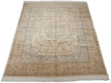 Angled perspective of a vintage Tabriz carpet in soft ivory, beige, and powder blue.
