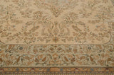 Floral vines on the ivory field and powder blue border of a vintage Tabriz rug.