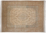 A hand-knotted vintage Tabriz carpet with its tone-on-tone ivory field and sharp scalloped medallion.