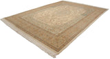 Angled view of the entire vintage Tabriz carpet, showcasing its ivory central medallion and detailed borders.