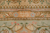 Close-up of the full pile and intricate border of a vintage Tabriz in terracotta and powder blue.